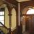 Main stair after restoration, including replication of the open fretwork, refinished woodwork, original paint colors and historic replica lighting
