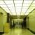 Before view of elevator corridor showing dropped ceiling, missing light fixtures and altered walls