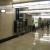 Completed view of the elevator corridor showing matching marble wall, restored ceiling and new light fixtures