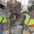 Workers lifting finial stones into place during the restoration